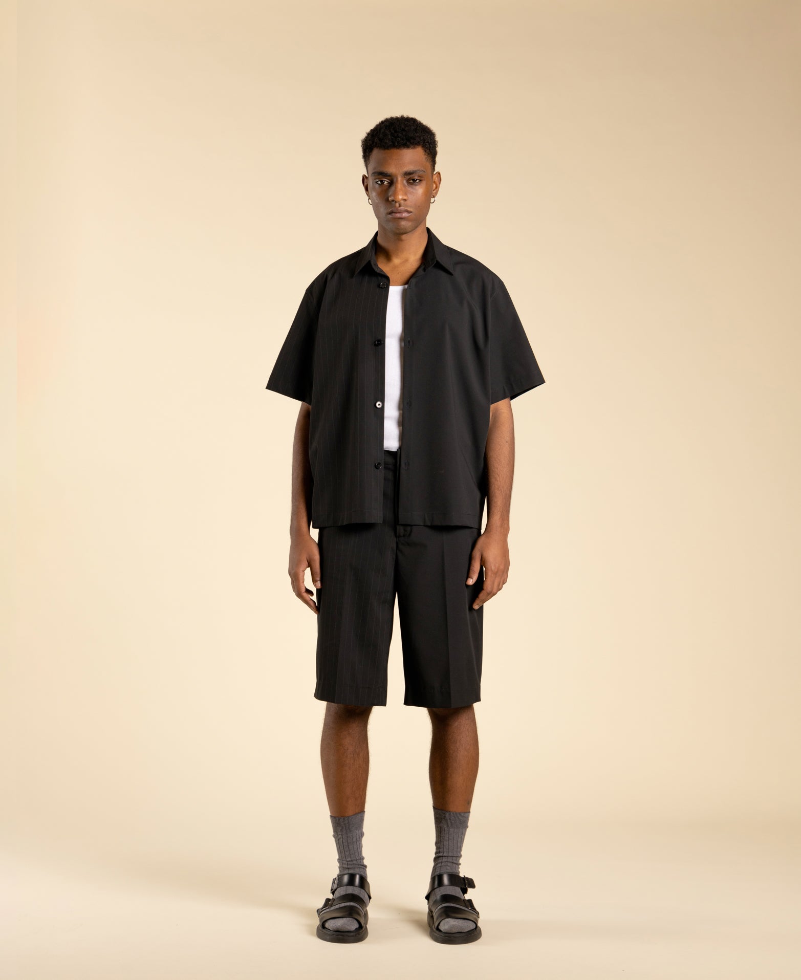 Wide, half-pinstriped Bermuda shorts in polyviscose